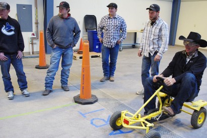 Students and staff members participate in a fatal vision obstacle course.