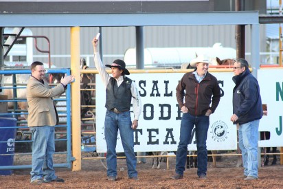  Edmiles Harvey shows off his bareback riding championship belt buckle at the Mesalands Community College Spring Rodeo. Buckle presenters (left) Dennis Roch, State Representative; Ty Marshall (middle), winner of the Mesalands Community College Foundation, Inc. “Rodeo Package;” and (right) Dr. Thomas W. Newsom, President of Mesalands.