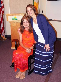 (Right) Natalie Gillard, Vice President of Academic Affairs at Mesalands Community College, presents Susan Reid, Library Technician, with a retirement gift, a rocking chair for her 25 years of service, during the retirement celebration.