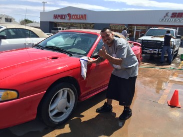 Marcos Martinez, President of the Hispanic Heritage Club ‘Amistad’ at Mesalands Community College, washing cars and having fun at their recent car wash, which raised over $200. 
