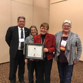 (Left) Dr. Thomas W. Newsom, President of Mesalands Community College; Andrea Hodge and (Right) Phyllis Roybal, Members of the New Mexico Art Education Association (NMAEA), present D’Jean Jawrunner, Fine Arts Faculty Member at Mesalands Community College, with her award during the 2015 NMAEA State Conference last weekend in Taos, NM.