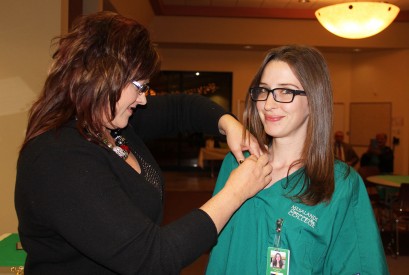 Caption. (Left) Jeanne Moralez, Allied Health Program Faculty Member, gives Jennie Hall, Mesalands Student, her Allied Health pin during a Pinning Ceremony last week. 