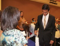 Yash Shah, student at Mesalands Community College, lights his candle during the Phi Theta Kappa Induction Ceremony.