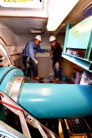 Dr. Thomas W. Newsom, President of Mesalands Community College and Brett Clark, recent graduate of the Wind Energy Technology Program at Mesalands Community College, stand inside the nacelle of the wind turbine.