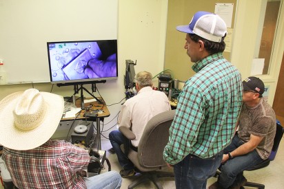 (Front) Russell Yates, world-renowned fabricator and engraver, demonstrates some of his engraving skills that are projected on the screen for students taking the ART 2931: Special Topic in Silversmithing course at Mesalands Community College. Yates, Shawn Didyoung (Back), and Eddy Mardis (not in photo) instructed this advanced Artistic Silversmithing course last week.