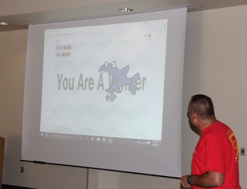 Brian Montoya, Director of RoboRAVE International at Inquiry Facilitators, Inc. and the instructor of the Robotics Academy, explains how Taylor Enriquez used source code to develop the game of the shark, trying to eat the fish around him. 