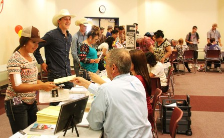 (Right) Dr. Aaron Kennedy, Vice President of Student Affairs at Mesalands, hands-out a Directory of Local Resources booklet at the Campus Safety booth, during Student Orientation last week.