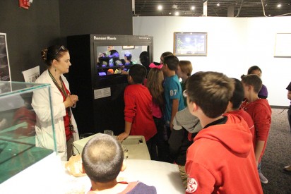 Gretchen Gürtler, Director of the Mesalands Community College’s Dinosaur Museum and Natural Sciences Laboratory, gives a guided tour to elementary-age children at the Mesalands Dinosaur Museum. 