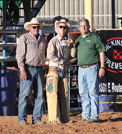 (Left) Roger Walters, the National Intercollegiate Rodeo Association (NIRA) Commissioner and Dr. Thomas W. Newsom, President of Mesalands Community College, presents Kenneth “Blue” Wilcox, a member of the Mesalands Rodeo Team, with the bull riding championship buckle he won at the 9th Annual Mesalands Grand Canyon Region Intercollegiate Fall Rodeo at the Quay County Rodeo Arena last weekend.